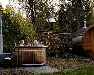Ontspannen in de hot tub bij vakantiehuisje in Rillaar, Vlaams-Brabant, omgeven door bomen.