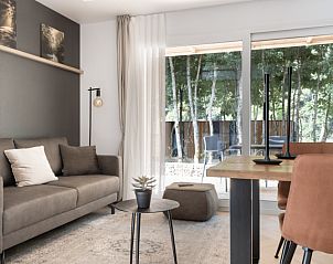 Cozy living room in Chalet in Mol, vacation home in Mol, Antwerp, overlooking a wooded area and modern interior.