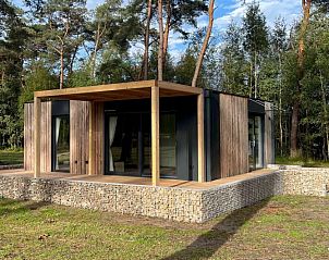 Chalet in Mol, a vacation home in Antwerp, Belgium, surrounded by nature with an inviting terrace for relaxation.