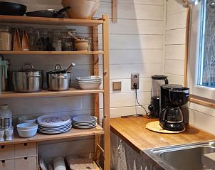 Fully equipped kitchen in Cottage in Oud-Turnhout, vacation home in Antwerp, Belgium, with wooden shelves and modern appliances.