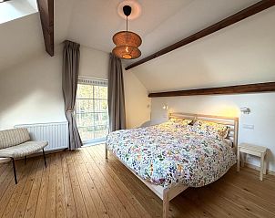 Cozy living room of Lierelodge, a vacation home in Oud-Turnhout, Antwerp, with modern fireplace and television for ultimate comfort.