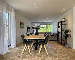 Stylish dining room in Sahara119 vacation home, Lommel, Limburg overlooking the garden.