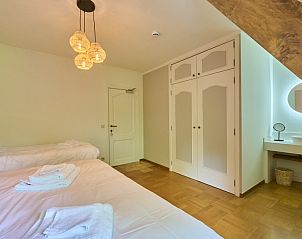 Attractive bedroom with wooden elements in Villa Bosrijk, vacation home in Lommel, Belgium.