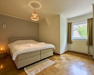 Cozy bedroom in Villa Bosrijk, Lommel, with large bed and lots of natural light.