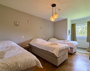 Family room in Villa Bosrijk, Lommel, with multiple beds and a relaxing atmosphere.