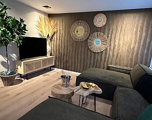 Cozy living room of Cottage in Lanaken, vacation home in Lanaken, Limburg, Belgium. Modern decor with comfortable seating and decorative elements.