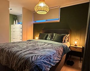 Cozy bedroom in Cottage in Lanaken, vacation home in Lanaken, Limburg, Belgium with atmospheric lighting and comfortable bed.
