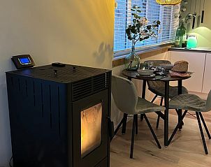 Cozy indoor space in Cottage in Lanaken, Limburg with cozy dining area and cozy wood stove, ideal vacation home in Belgium.