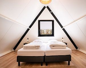 Cozy bedroom in Holiday Home in Lanaken, Limburg, Belgium with comfortable beds and restful views.
