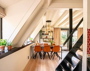 Cozy indoor area of Holiday Home in Lanaken, Limburg, Belgium with modern dining room and views of green surroundings.