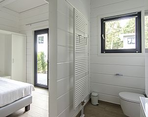 Bright bedroom and bathroom in Mooi Zutendaal 4-person villa, located in green Limburg, Belgium.