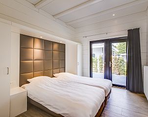 Attractive bedroom in Mooi Zutendaal 4-bedroom villa in Limburg, Belgium, with garden views and modern furnishings.