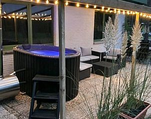 Relax on the cozy terrace of Cottage in Lanaken, Gellik, Limburg. Enjoy the luxurious outdoor space with jacuzzi and comfortable seating area.
