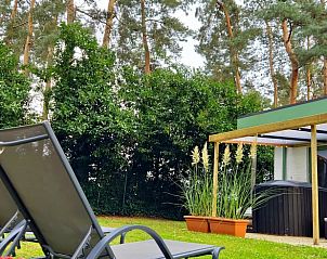 Relax on the terrace of Cottage in Lanaken, a vacation home in Gellik, Limburg, Belgium, surrounded by nature and peaceful green surroundings.