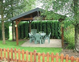 Covered terrace at Zur Krombisch in Elsenborn, Ardennes, ideal for relaxed outdoor meals.