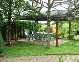 Cozy pavilion in the garden of vacation home Zur Krombisch, Elsenborn, surrounded by green nature.