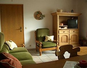 Comfortable living room in vacation home Zur Krombisch, Elsenborn, with classic furniture and cozy atmosphere.