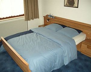 Spacious double bedroom in vacation home Zur Krombisch, Elsenborn, for a relaxing stay.
