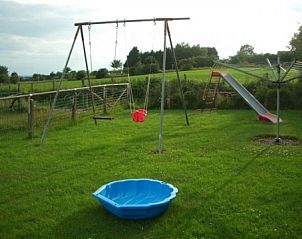 Play area with swing and slide in the garden of Zur Krombisch, Elsenborn, perfect for children.