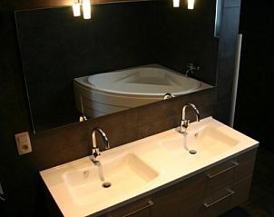 Modern bathroom with double sink in Herresbach vacation home, Ardennes, Belgium.