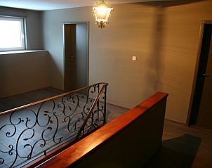 Stairs with ornate handrail in vacation home Herresbach, located in Herresbach, Ardennes.