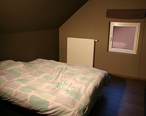 Cozy bedroom with skylight in Herresbach vacation home, Ardennes, Belgium.