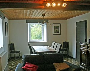 Dining room overlooking the garden in Herresbach vacation home, Ardennes, Belgium.