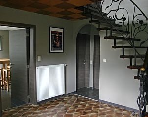 Stairs with wrought iron handrail in vacation home Herresbach, located in the Ardennes.