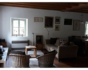 Cozy living room in Holiday Home in Ottr, located in the Ardennes, Lige, Belgium, with comfortable seating and country charm.