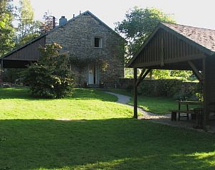 Vacation home in Ottr, a charming cottage in the Ardennes, Lige, Belgium, surrounded by greenery with an inviting terrace.
