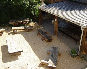 Outdoor space with wooden seating in Maison Del Campo, vacation home in the Ardennes.