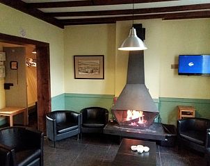Cozy sitting area with fireplace in Maison Del Campo, vacation home in the Belgian Ardennes.