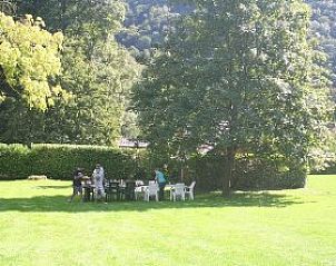 Cozy sitting area in the garden of vacation home Windsor, surrounded by the green landscape of Waulsort, Ardennes.