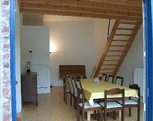 Cozy dining room with wooden stairs in vacation home Windsor, located in picturesque Waulsort, Ardennes.