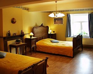 Spacious bedroom with wooden beds in Les Gronsarts Vencimont vacation home in Ardennes, Vencimont, Belgium.