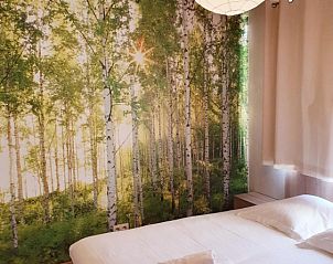 Bedroom with forest motif wallpaper in Gite Entre Roches et Nature, vacation home in Dinant, Ardennes, Belgium.