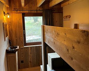Cozy bedroom with wooden bunk bed in vacation home Le Refuge, Achouffe, Ardennes, Belgium. Perfect for a cozy nature vacation.