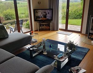 Bright living room in Holiday Home Ardennes, Durbuy, Belgium with panoramic views of nature and comfortable seating area.