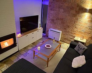 Cozy living room in Cottage in Izier, Ardennes with cozy fireplace and modern decor, ideal for relaxation in Luxembourg, Belgium.