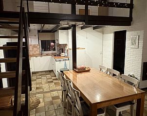 Cozy indoor area of Holiday Home in Izier, Ardennes, with spacious dining table and modern kitchen for a comfortable stay.