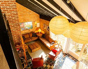 Gemtliches Wohnzimmer im Ferienhaus in Durbuy, Izier, mit Holzbalken und warmer Einrichtung, gelegen in den Ardennen, Luxemburg, Belgien.