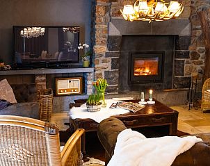 Cozy living room with fireplace in Cottage in Houffalize, vacation home in the Ardennes, Luxembourg, Belgium.