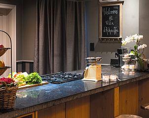 Cozy kitchen in cottage in Houffalize, vacation home in the Ardennes, Belgium, with modern furnishings and attractive details.