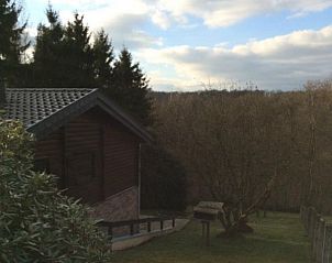 Rustic charm of Chalet Ma Reine in Remouchamps, Ardennes, overlooking wooded countryside.