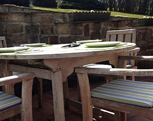Cozy terrace at Chalet Ma Reine in Remouchamps, Ardennes, perfect for outdoor dining.