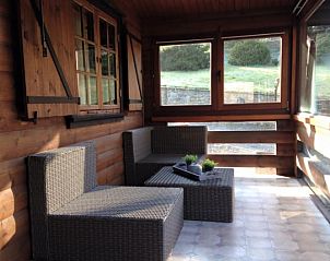 Cozy veranda of Chalet Ma Reine in Remouchamps, Ardennes, ideal for relaxation.