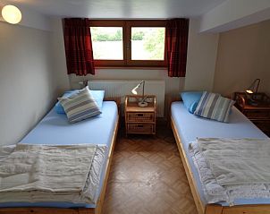 Comfortable bedroom in La Terra vacation home Durbuy, with wooden beds.