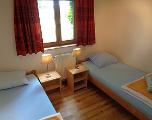Bedroom with two beds in La Terra vacation home Durbuy, cozy and bright.