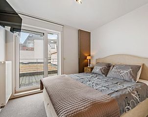 Cozy bedroom in Jacob Van Maerlant - V1 vacation home, Blankenberge, with comfortable bed and access to balcony on the Belgian coast.