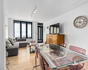 Cozy living room of vacation home Badersstraat 3 in Blankenberge, Belgian coast, with modern furnishings and spacious dining area.